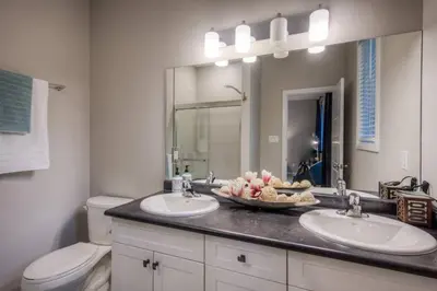 a bathroom with two sinks and a toilet at BRAND-NEW LUXURY SUITE in DOON SOUTH, min to 401 in Kitchener