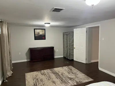 an empty living room with a dresser and a door at Home by Dolly in Toronto