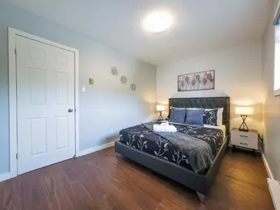 a bedroom with a bed and a white door at Pet-Friendly Large 3-Bedroom - Bobcaygeon in Bobcaygeon