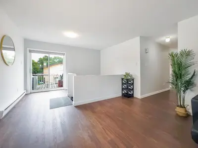 an empty living room with white walls and wood floors at Pet-Friendly Large 3-Bedroom - Bobcaygeon in Bobcaygeon
