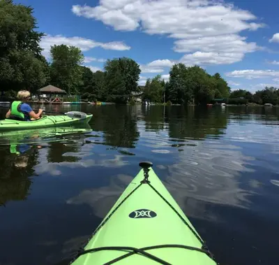 a person in a kayak on a lake at Pet-Friendly Large 3-Bedroom - Bobcaygeon in Bobcaygeon