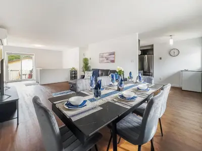a dining table and chairs in a living room at Pet-Friendly Large 3-Bedroom - Bobcaygeon in Bobcaygeon