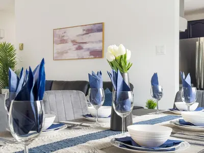 a dining table with blue and white dishes and wine glasses at Pet-Friendly Large 3-Bedroom - Bobcaygeon in Bobcaygeon