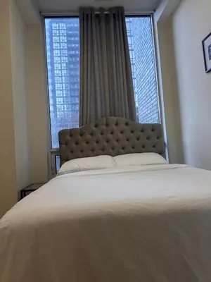 a bedroom with a large bed and a large window at Quiet Room In A Guest House in Mississauga