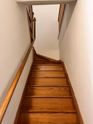 a staircase in a house with wooden floors and white walls at Quiet Room In A Guest House in Mississauga