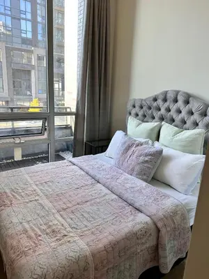 a bedroom with a bed and a large window at Quiet Room In A Guest House in Mississauga