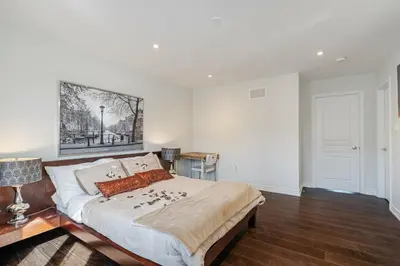 a bedroom with a bed with a painting on the wall at Meadowcrest Semi in Mississauga
