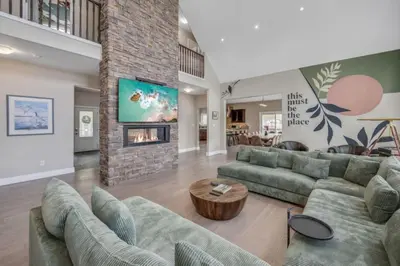 a large living room with couches and a fireplace at LUX Lakefront Sleeps18 Pickleball HotTub Sauna Gym Arcade Basketball Volleyball in Buckhorn