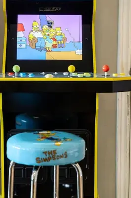 a table with a tv and a blue stool at LUX Lakefront Sleeps18 Pickleball HotTub Sauna Gym Arcade Basketball Volleyball in Buckhorn