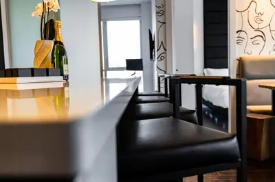 a room with a table and chairs and a bottle of wine at PARC LOFT Penthouse with 4bd-WFH-PS5-CN Tower Views in Toronto