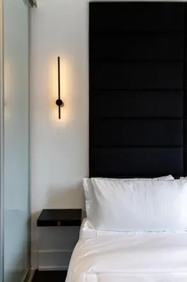 a bedroom with a black headboard and a white bed at PARC LOFT Penthouse with 4bd-WFH-PS5-CN Tower Views in Toronto