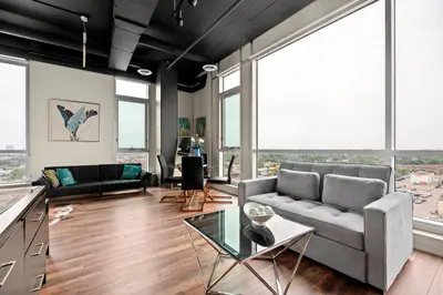 a living room with a couch and a table at Finch West Residence Suites - Hotel DUKE in Toronto