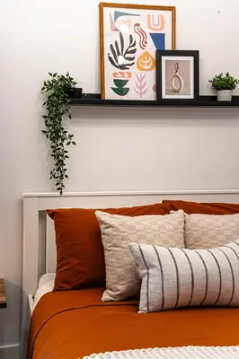 a shelf above a bed in a bedroom at The Hideaway Hub in Toronto