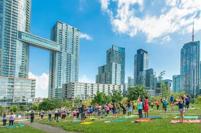 a group of people in a park with buildings at The Hideaway Hub in Toronto