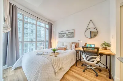 a bedroom with a desk and a bed and a desk at The Hideaway Hub in Toronto