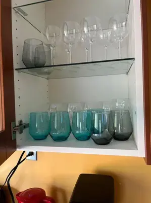 a row of blue glass bowls on a shelf at 45 per Off Monthly Stay - 7 Beds - BBQ in Kitchener