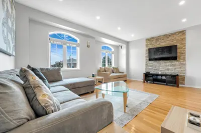 a living room with a couch and a fireplace at Elegant 3Bedroom with Smart TV and Backyard in Mississauga
