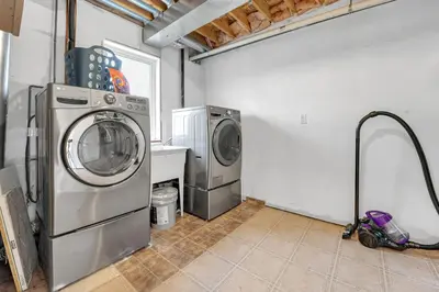 a laundry room with a washing machine and a washer at Elegant 3Bedroom with Smart TV and Backyard in Mississauga
