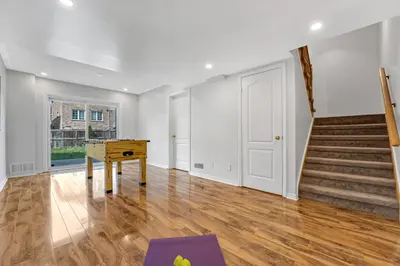 an empty living room with a table and stairs at Elegant 3Bedroom with Smart TV and Backyard in Mississauga