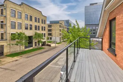 a balcony with a wooden walkway in a city at ENTIRE BACHELOR UNIT EN-SUITE ACROSS FROM GOOGLE - br4 in Kitchener
