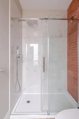 a shower with a glass door in a bathroom at ENTIRE BACHELOR UNIT EN-SUITE ACROSS FROM GOOGLE - br3 in Kitchener