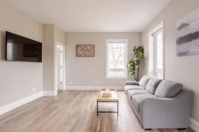 a living room with a couch and a table at ENTIRE BACHELOR UNIT EN-SUITE ACROSS FROM GOOGLE - br3 in Kitchener