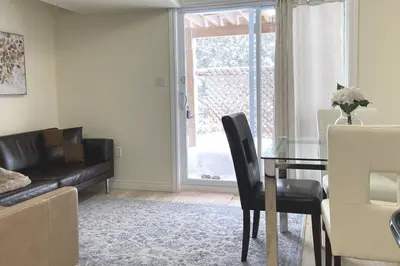 a living room with a dining room table and a couch at Basement Waterloo Near 24-7 Restraints in Waterloo