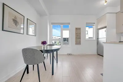 a kitchen and dining room with a table and chairs at Posh 4 Bed Home with Backyard in Great Location in Burlington