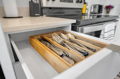 a tray of utensils in a drawer in a kitchen at Posh 4 Bed Home with Backyard in Great Location in Burlington