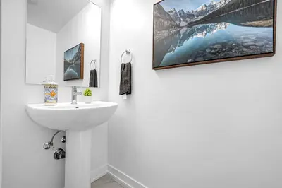 a bathroom with a sink and a picture on the wall at Posh 4 Bed Home with Backyard in Great Location in Burlington
