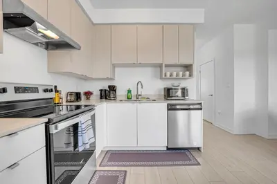 a kitchen with white cabinets and stainless steel appliances at Posh 4 Bed Home with Backyard in Great Location in Burlington