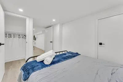 a bedroom with a bed with two towels on it at Luxury Comfort 3 BR Near Hospitals Tims Field GO in Hamilton