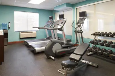 a gym with several tread machines in a room at Fairfield Inn & Suites by Marriott Barrie in Barrie