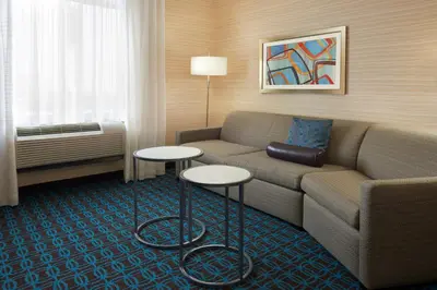 a living room with a couch and two tables at Fairfield Inn & Suites by Marriott Barrie in Barrie