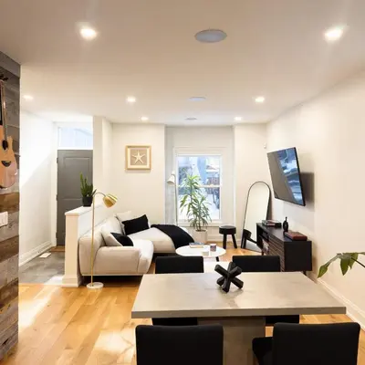 a living room with a couch and a table at Beautiful modern 2Bdr sunny home with French decor in Hamilton