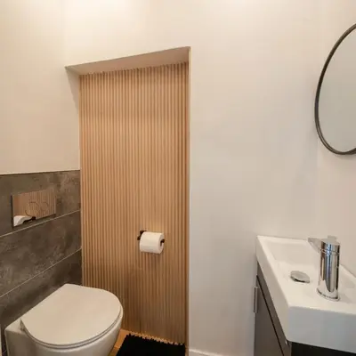 a bathroom with a toilet and a sink at Beautiful modern 2Bdr sunny home with French decor in Hamilton