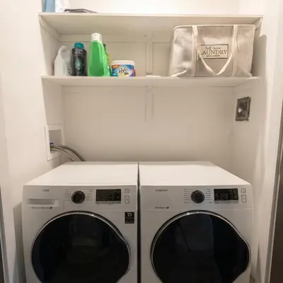 a washer and dryer in a small room at Beautiful modern 2Bdr sunny home with French decor in Hamilton
