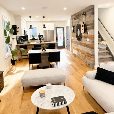 a living room with a couch and a table at Beautiful modern 2Bdr sunny home with French decor in Hamilton