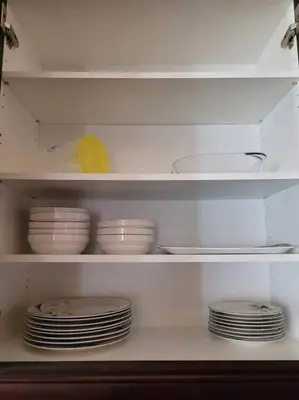 a white shelf with plates and bowls in a refrigerator at Huge Family home sleeps 10 with 3 parking spots in Kitchener