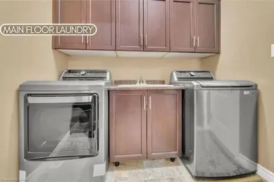 a kitchen with a stove and a dishwasher and cabinets at Huge Family home sleeps 10 with 3 parking spots in Kitchener