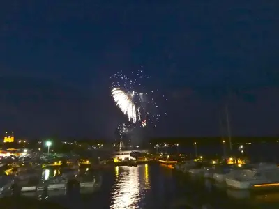 a firework in the sky over a marina at night at The Captain's House heritage bed & breakfast in Midland