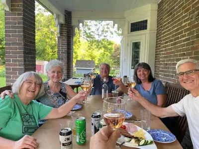 a group of people sitting at a table drinking wine at The Captain's House heritage bed & breakfast in Midland