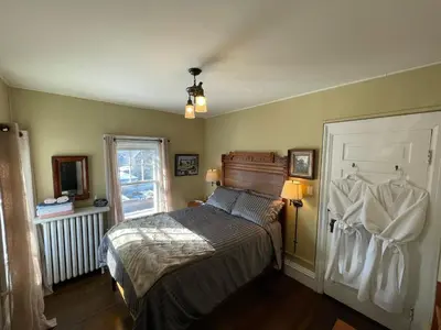 a bedroom with a bed and a window at The Captain's House heritage bed & breakfast in Midland