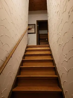 a staircase in a building with wooden steps at Bowering Lodge in Blue Mountains