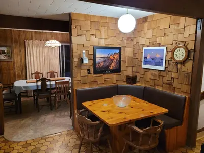 a dining room with a wooden table and a table and a dining room at Bowering Lodge in Blue Mountains