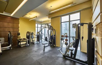 a gym with several tread machines in a room at View CN Tower and Lake from the Sky! in Toronto