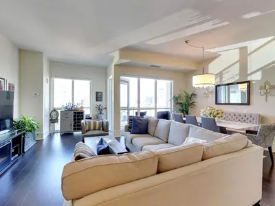 a large living room with a couch and a table at View CN Tower and Lake from the Sky! in Toronto