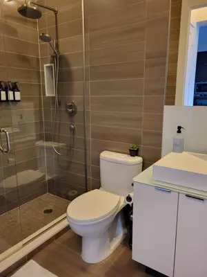a bathroom with a toilet and a shower at View CN Tower and Lake from the Sky! in Toronto