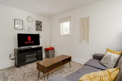 a living room with a couch and a tv at West House Private Garden Suite with Skylight in Brampton