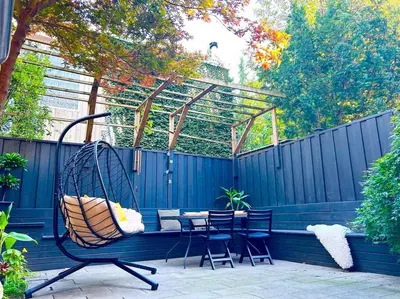 a swing on a patio with a table and chairs at Central Toronto in Toronto